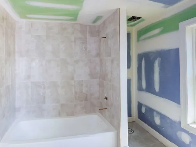 Completed modern bathroom renovation with new tiling on a residential project in Auckland